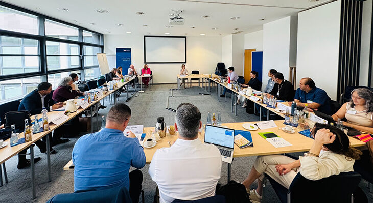 U-shaped tables; around 15 people are seated at U-shaped tables. 