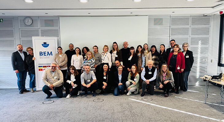 Participants of the micro credentials days sitting in front of the BEM logo.