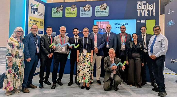 Internationale TGTA-Steuerungsgruppe auf der WorldSkills Conference Shanghai 2026 vor einer Messewand mit der Aufschrift „Towards a Global TVET Agenda“.